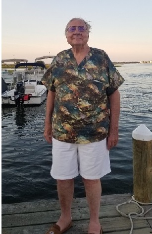 Man standing on dock by the water